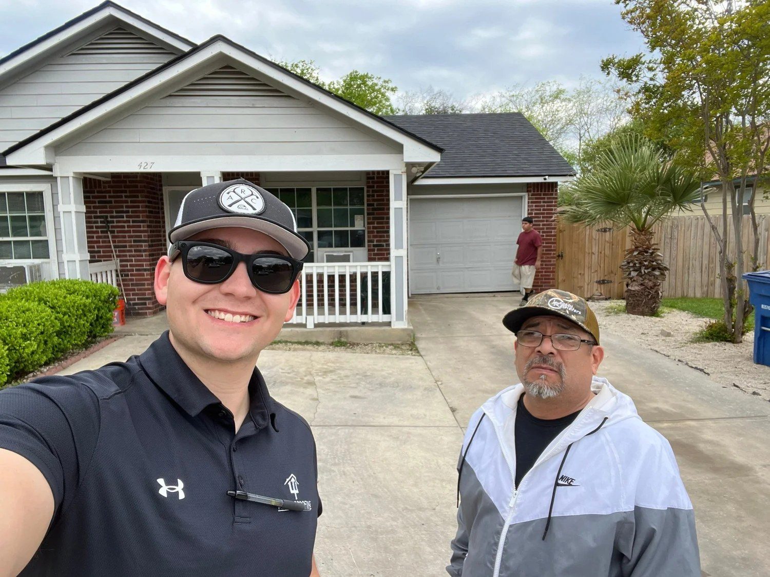 Trident Roofing team at a completed roof replacement in San Antonio